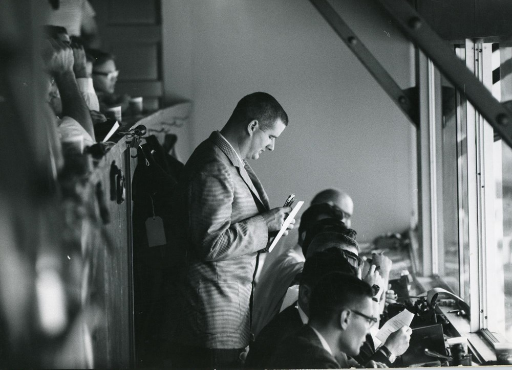 Cook working with the assembled media during a Pitt football game. Later in his career, his passion for football and his extensive knowledge earned Cook the nickname “The Pope of College Football.”